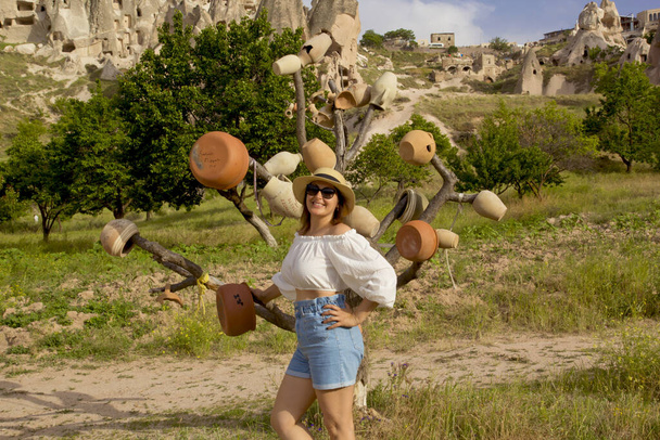 beautiful woman in a hat in uchisar castle in cappadocia, turkey - Photo, Image