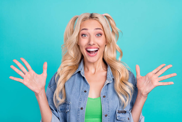 Photo of young happy cheerful amazed woman raise hands good mood news sale isolated on blue color background. - Фото, изображение