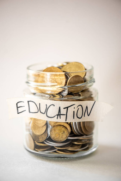 Coins in glass jar with education label. Financial concept. - Фото, зображення