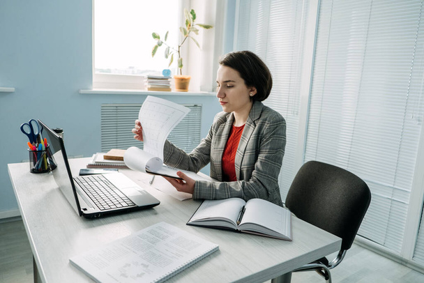 Time Management, Planning For Business Owners managers. Young Businesswoman, manager sitting at table in office and do notes in diary and calendar - Photo, Image