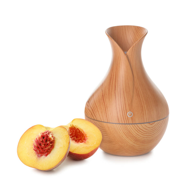 Aroma oil diffuser and peach on white background - Photo, image