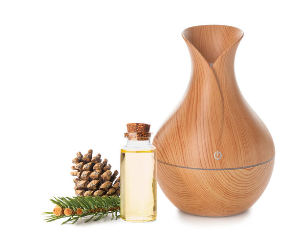 Aroma oil diffuser and coniferous essential oil on white background - Foto, imagen