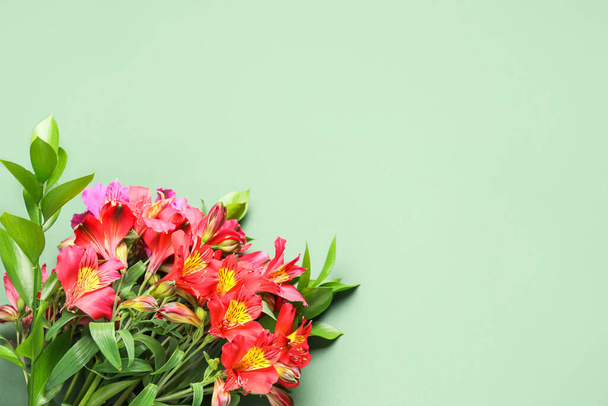 Bouquet of alstroemeria flowers on green background - Фото, изображение
