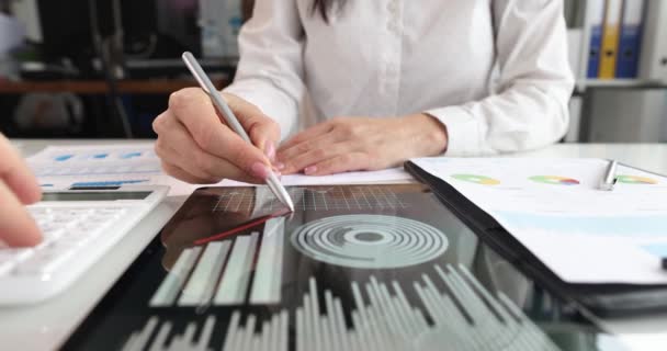 Woman draws arrows on tablet with analytics.Business statistics and marketing concept - 映像、動画