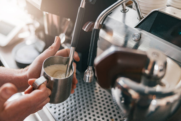 Professional barista warming milk In metal jug with steam of coffee machine. High quality photo - Fotoğraf, Görsel