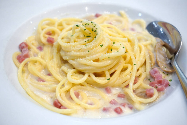 Spaghetti Carbonara Italian cuisine on white dish - Fotó, kép