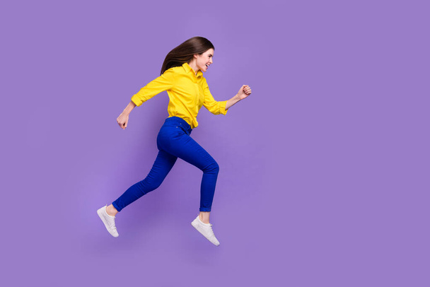 Full length body size view of attractive cheery girl jumping running copy space isolated over bright violet purple color background. - 写真・画像