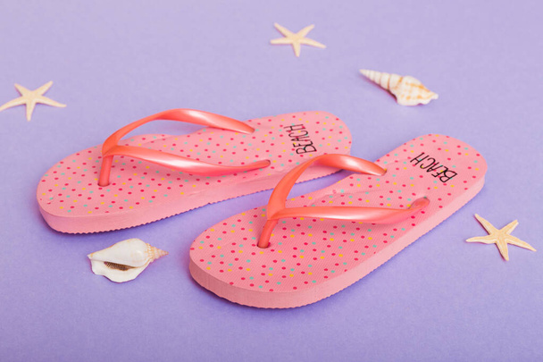 Beach accessories. Flip flops and starfish on colored background. Top view Mock up with copy space. - Fotografie, Obrázek