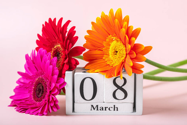 Bouquet of gerbera flowers, calendar with date 08 march on pink background Holiday greeting card International womens day concept Flat lay Top view. - Photo, image