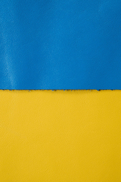 A roll of blue and yellow leather. Ukrainian leather production. Factory for sewing shoes in Ukraine - Foto, afbeelding
