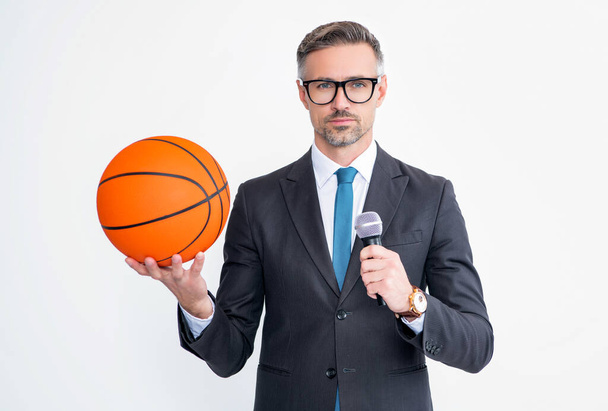 mature man in suit hold basketball ball and microphone isolated on white background. - Fotó, kép