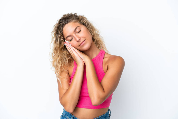 Girl with curly hair isolated on white background making sleep gesture in dorable expression - Fotografie, Obrázek