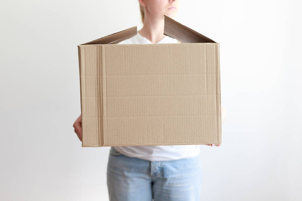 woman with cardboard delivery box close-up. delivery, donations - Fotoğraf, Görsel
