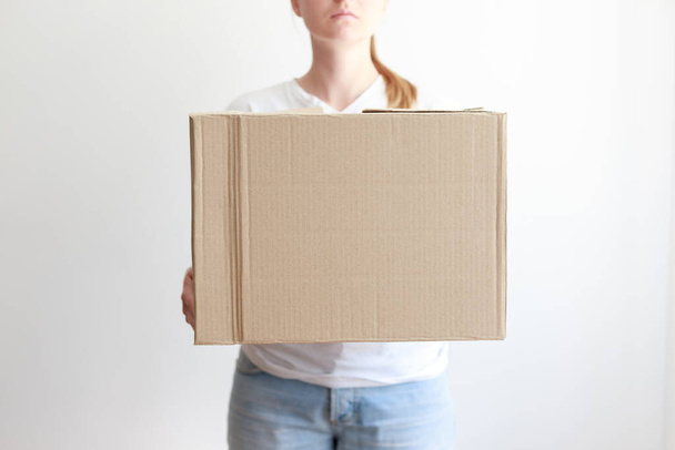 woman holding a cardboard box close-up - Photo, Image