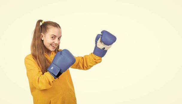 hobby. child boxer isolated on white background. sport success. active and healthy childhood. knockout. she will fight. happy kid punching. fist to fight. teen girl in boxing gloves. angry attack. - Zdjęcie, obraz