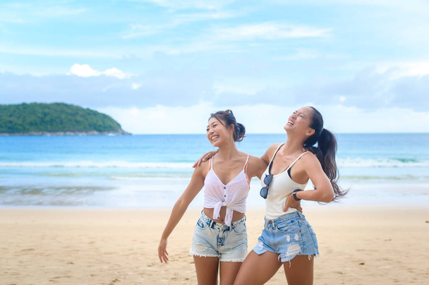 Two attractive women friends enjoying and relaxing on the beach,  Summer, vacation, holidays, Lifestyles concept. - Foto, Imagen