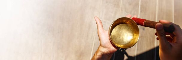 Man hands using singing bowl in sound healing therapy outdoors, closeup banner - Photo, Image