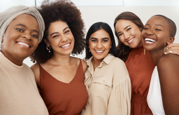 Happy diverse group of young female friends taking a selfie together. Team of cheerful and joyful businesswomen smiling taking a photo in an office at work. - Photo, Image