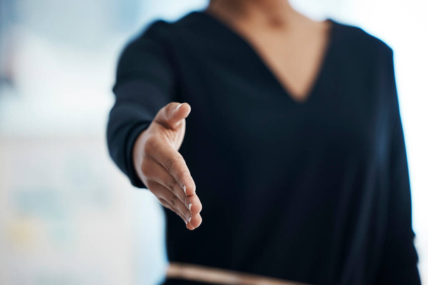 Closeup of a confident mixed race business woman reaching out a hand for a handshake. This symbolizes teamwork, partnership and reaching an agreement or making a deal. Congratulating one on promotion. - Foto, Bild