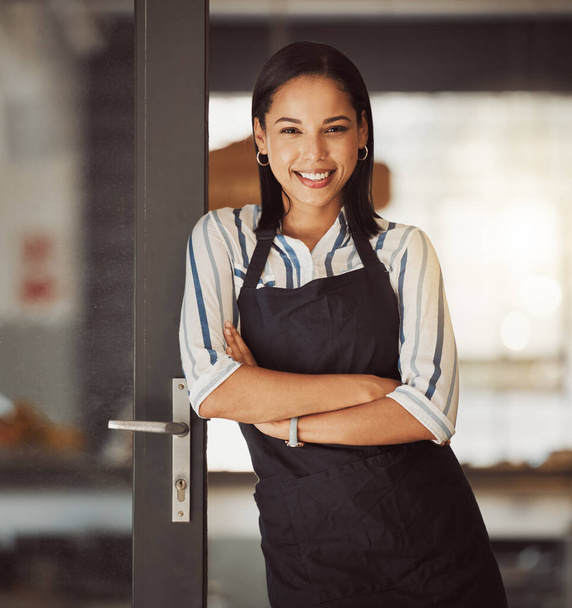 Beautiful businesswoman standing in her cafe entrance. Mixed race boss arms crossed in her coffeeshop. Bistro owner standing in her restaurant entrance. Portrait of small business owner in her store. - Foto, immagini