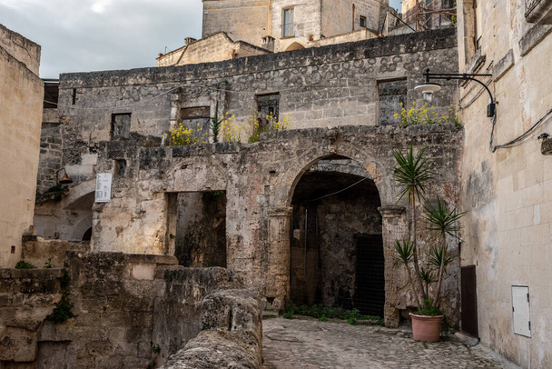 Ancient medieval alleyway somewhere in the historic town of Matera, Italy - Photo, image