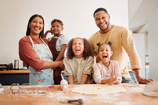 A happy mixed race family of five relaxing and cooking together. Loving black family being playful while baking together. Young couple bonding with their foster kids at home in a messy kitchen. - Foto, Imagem