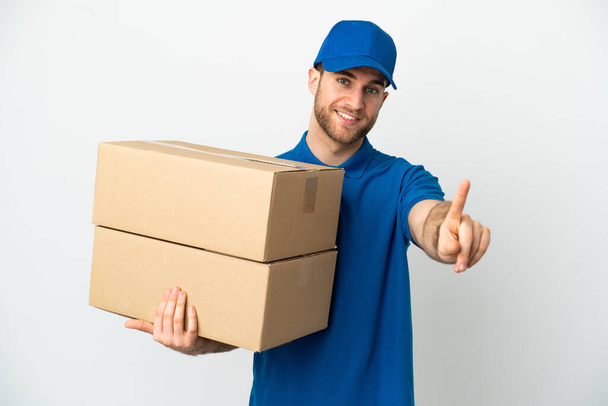 Delivery man over isolated white background showing and lifting a finger - Photo, Image
