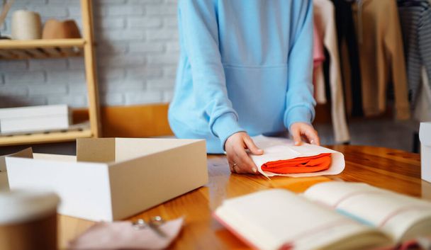Close-up of preparing a parcel on the table. Online small business entrepreneur merchants working at store preparing products to deliver to customers. Dropshipping delivery concept. - Fotó, kép