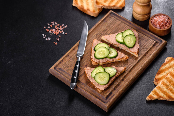 Delicious fresh sandwich with chicken liver pate with crispy toast, butter and cucumber. Quick healthy snack - Фото, зображення