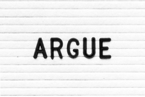 Black color letter in word argue on white felt board background - Photo, Image