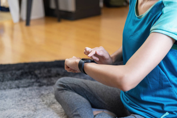 Relieve stress, relax muscles, practice breathing, exercise, meditate. Women exercise using smart watch to record exercise data. - Photo, image