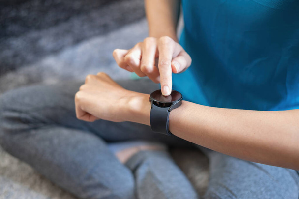 Relieve stress, relax muscles, practice breathing, exercise, meditate. Women exercise using smart watch to record exercise data. - Photo, Image