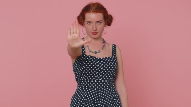 No, Stop. Serious woman say No, hold palm folded crossed hands in stop danger gesture, warning of finish, prohibited access, declining communication, body language. Redhead girl on pink background - Filmati, video