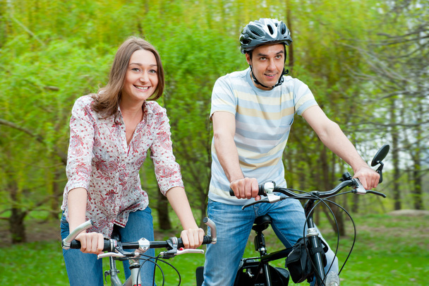 Happy young couple riding bicycles - Fotó, kép