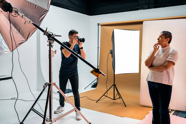 Stock photo of professional photographer during photo shoot in studio. - Foto, Imagem