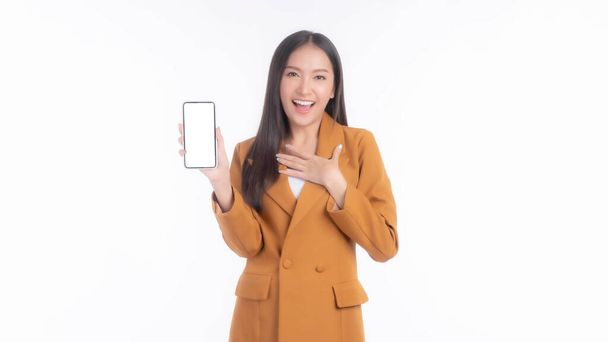красива азіатська молода жінка, вражена здивованою дівчиною, яка показує смартфон з чистим екраном, білий екран ізольований на білому тлі, Mock Up Image - Фото, зображення