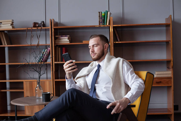 Young man holding smartphone for business work. - Foto, Imagem