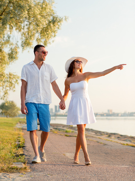 smiling couple walking outdoors - 写真・画像