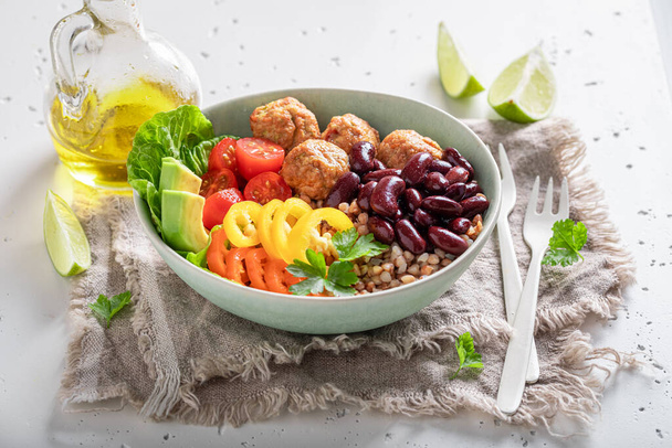 Spicy Mexican salad with groats, meatballs, limes and vegetables. Nutritious bowl for fit people. - Zdjęcie, obraz