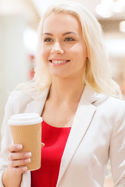 happy young woman with coffee paper cup in mall - Fotografie, Obrázek