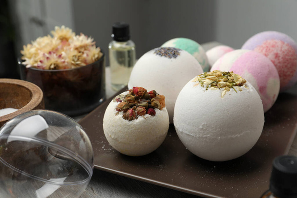 Plate with different bath bombs on wooden table, closeup - Foto, immagini