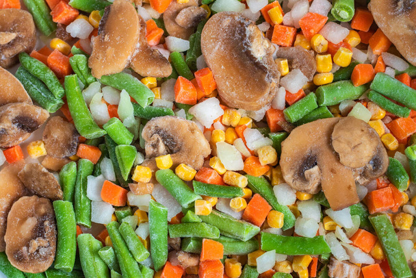 Chopped frozen vegetables background. Corn peas pepper carrots. - Foto, Imagen