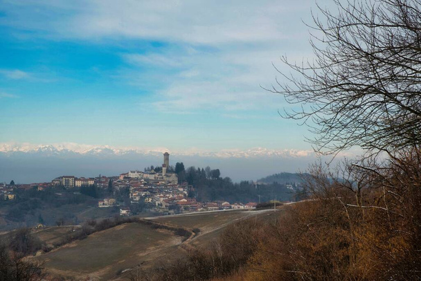 the village of Murazzano with its medieval tower in the Piedmontese Langhe, on a spring morning in 2022 - Photo, Image