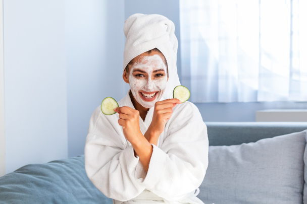 Natural homemade fresh cucumber facial eye pads facial masks. Woman holding cucumber pads and smile relax with natural homemade. A picture of a face of a beautiful woman posing with a cucumber - Fotoğraf, Görsel