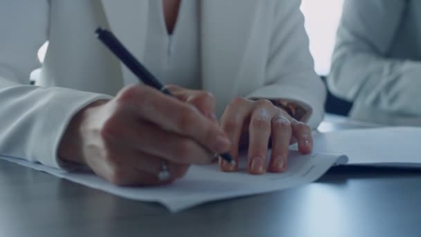 Closeup hand holding pen writing papers in suit. Divorcing woman signing documents in attorney office. Unrecognized client taking bank loan checking agreement. Freelancer ceo concluding financial deal - Séquence, vidéo