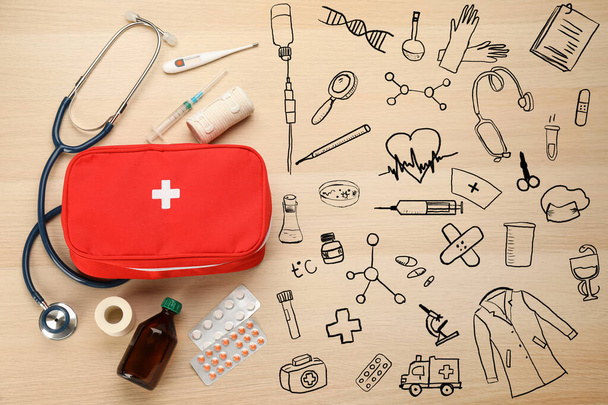 First aid kit and different images on light wooden table, flat lay - Φωτογραφία, εικόνα