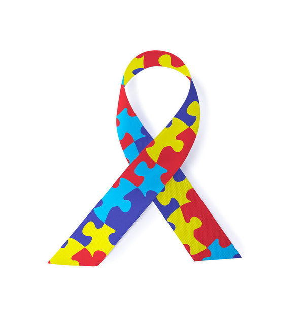 World Autism Awareness Day. Colorful puzzle ribbon on white background, top view - Zdjęcie, obraz