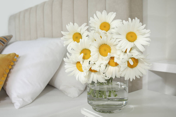 Bouquet of beautiful daisy flowers on table in bedroom, space for text - Photo, Image