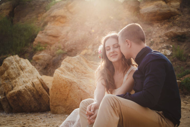 Outdoor beach wedding ceremony, close up of stylish happy romantic couple together sitting in sunlight. - Photo, Image