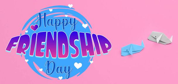 Paper whales and text HAPPY FRIENDSHIP DAY on pink background - Photo, Image